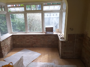 Damp affected wall before treatment in Purley London