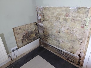 Removal of damp contaminated plaster during Raynes Park damp proofing works