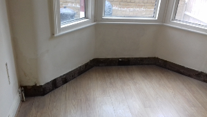 Damp affected wall before treatment in Reigate Surrey