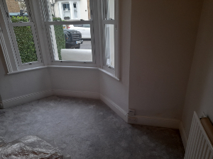 Damp damaged plaster before treatment Sutton