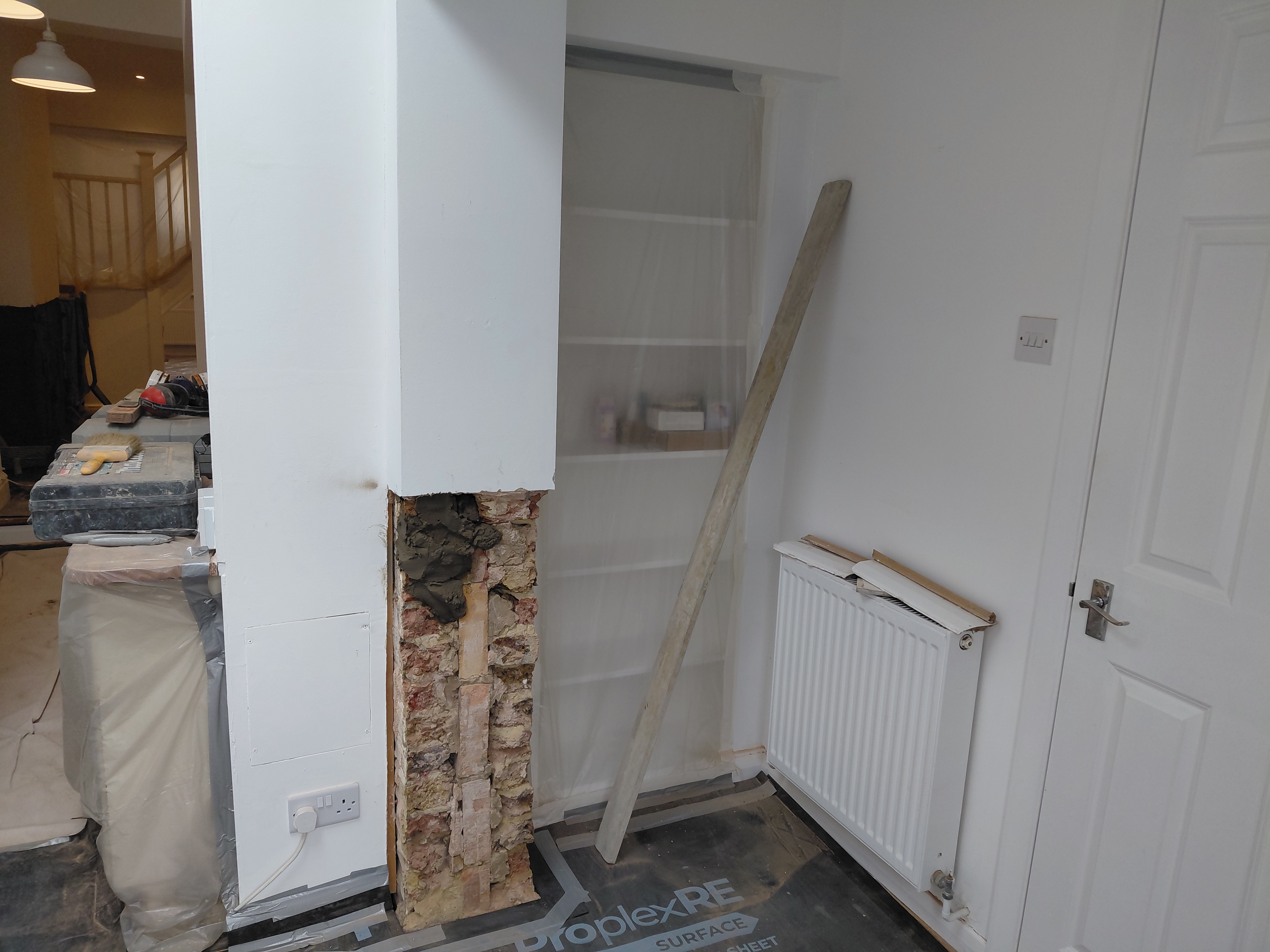 Damp proof course installation during rising damp treatment in Carshalton